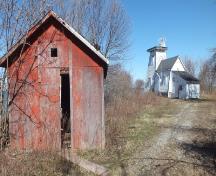 General view of Prince Edward Point Lighthouse with the shed in foreground; Marc Séguin, 2016.