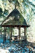 View of the entrance to the Rustic Lookout Pavilion, showing its decorative railing between posts, 1997.; Parks Canada Agency / Agence Parcs Canada, 1997.