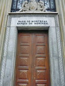 General view of the Bank of Montreal, showing its central doorways with a carved moulding and a superimposed sculpture of the bank’s coat of arms above, 2011.; Parks Canada Agency / Agence Parcs Canada, M. Therrien, 2011.