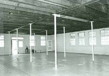 Interior view of the Small Dairy Barn, showing the parged concrete foundation, 1987.; Parks Canada Agency / Agence Parcs Canada, 1987.