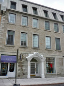 General view of the the Jeanne D'Arc Institute showing the tripartite elevation consisting of a dressed stone ground storey with shop window, separated by a wide string course from the two upper storeys, 2011.; Parks Canada Agency / Agence Parcs Canada, M. Therrien, 2011.
