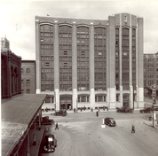 View of the exterior of the Federal Building, showing the strong vertical emphasis of the elevation defined by narrow brick piers which extend the full height of the building, 1938.; Library and Archives Canada / Biblothèque et archives Canada, PA 61811, 1938.