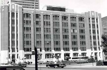 View of the façade of the Federal Building, showing the use of metal spandrels between each of the wide windows, which visually unites the space between the piers into a series of elongated panels, 1978.; Parks Canada Agency / Agence Parcs Canada, 1978.
