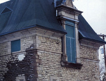 Detail of masonry and Renaissance-style windows breaking the eave line at the second storey.; Parks Canada | Parcs Canada