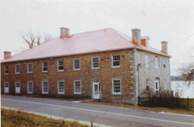 General view of the Carillon Barracks, showing the multi-paned, wooden sash windows along the side façade, 1977.; Parks Canada Agency / Agence Parcs Canada, 1977.