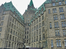Side view of the Confederation Building showing the rich blending of dormers, turrets, oriels, pavilions and towers, with extensive corbelling and carved detailing in the stonework, 2011.; Parks Canada | Parcs Canada, M. Therrien, 2011.