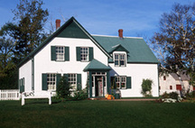 View of the main entrance of Green Gables House, showing the one-and-a-half storey, L-shaped massing topped by a gable roof with a dormer window on the front façade and the small vestibule entrance, 2000.; Parks Canada | Parcs Canada, J. Sylvester, 2000.