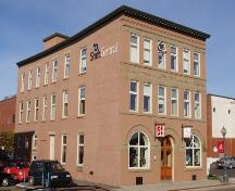 The Times Building, looking west.  The façade of this structure still maintains the Italianate architectural details of the original brick structure built 1902.; Moncton Museum