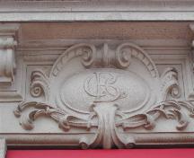This is one of eight CBC (Canadian Bank of Commerce) emblems that are located below bracketed ledges under the second floor windows, 2004 ; City of Saint John