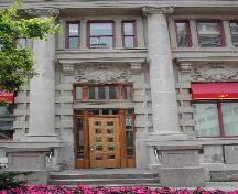This photograph shows the entrance to the bank, large corinthian columns, and brickwork, 2004; City of Saint John